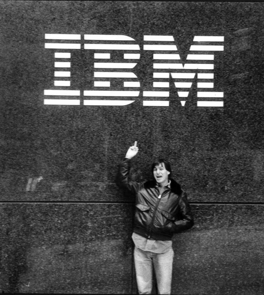 Photo of Apple co-founder Steve Jobs flipping off the IBM logo.