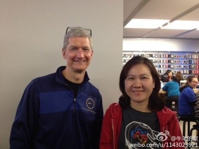 Apple CEO Tim Cook poses with fan at the company's Xidan Joy City store in Beijing.