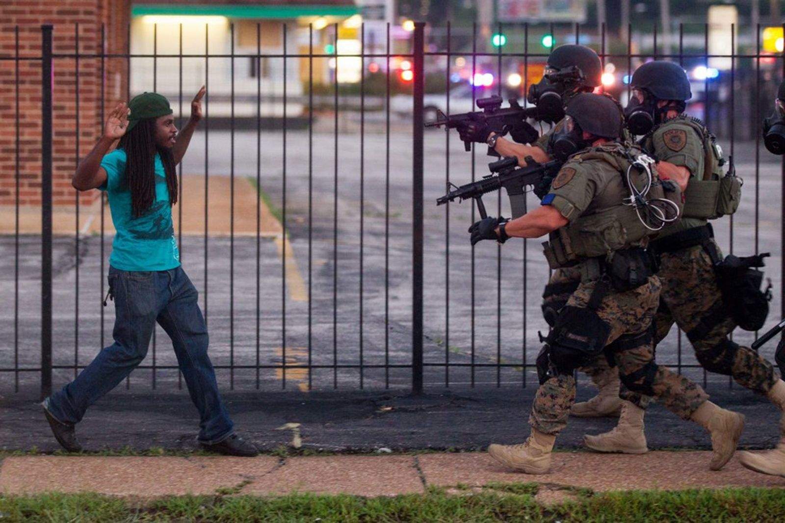 Police officers confronted a man protesting the shooting of a black teenager, Michael Brown, in Ferguson, Mo. (Whitney Curtis/for The New York Times)