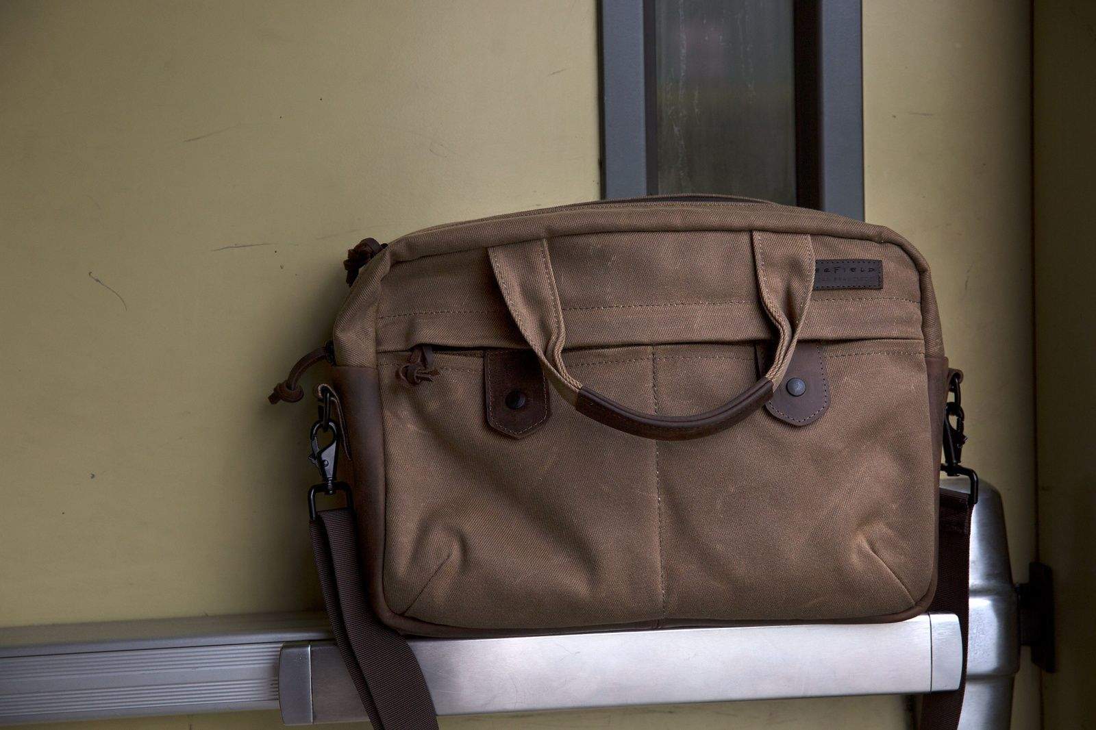 WaterField Designs' Bolt briefcase is not for hoarders who want to carry every infernal gadget with them everywhere they go. Like the impossibly thin new MacBook, it's stripped down to the essentials &mdash; and the essentials are stylish, sturdy and compelling.


The $249 Bolt will surprise you with its slimness. It comes in two sizes &mdash; the small one I tested holds up to a 13-inch MacBook Air (the larger model holds up to a 17-inch laptop). After sliding in an 11-inch Air, an iPad and an envelope full of documents, the Bolt was fairly full; there was barely room to toss in a pair of headphones. 


But that's the point of the Bolt. It's designed for carting around your must-have gear in a sleek, pleasing package. The brown waxed canvas bag looked good out of the gate (and even better after a few trips gave it more character). The chocolate leather accents, including a thick bottom that's perfect for keeping grime at bay, seem like they will only look better over time.


The craftsmanship employed by the San Francisco bag maker is evident from the first zip of the Bolt's hefty, waterproof zipper or the first flip of the 
