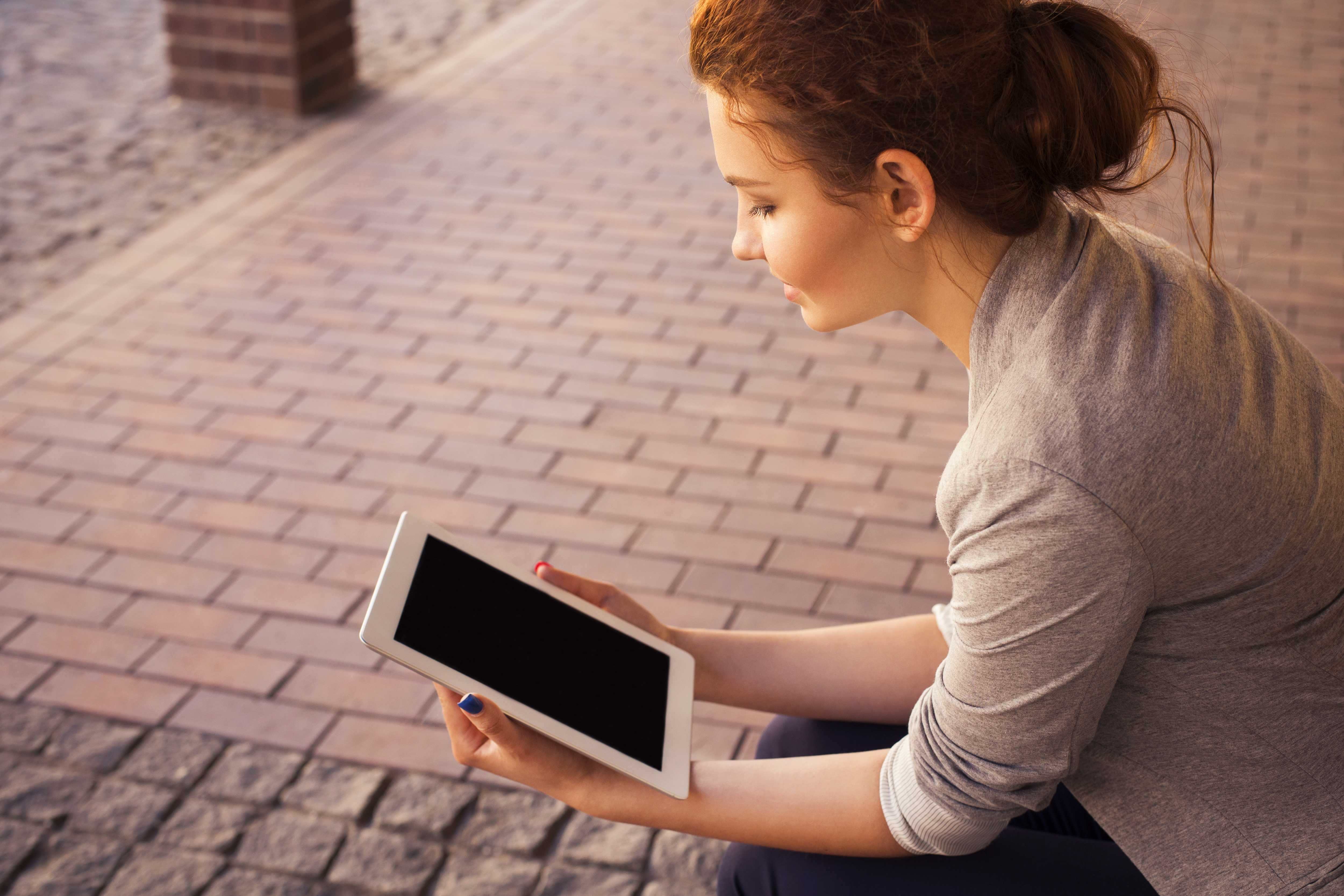 This girl is using her iPad, but you probably aren't