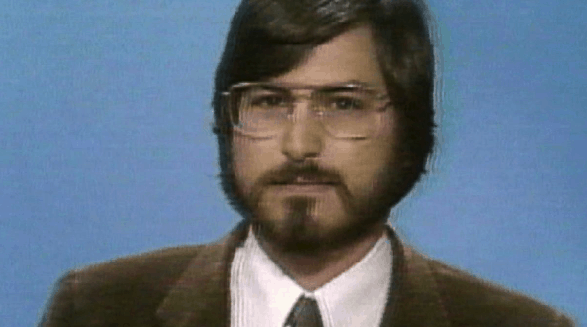 TV screen grab of Apple co-founder Steve Jobs dressed in a suit and with a full beard