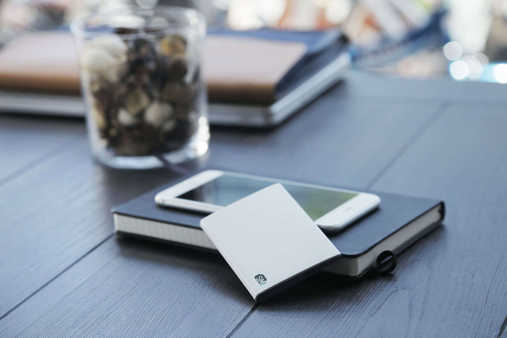 Carry an extra iPhone or carry a SIMpro to manage that extra phone line.