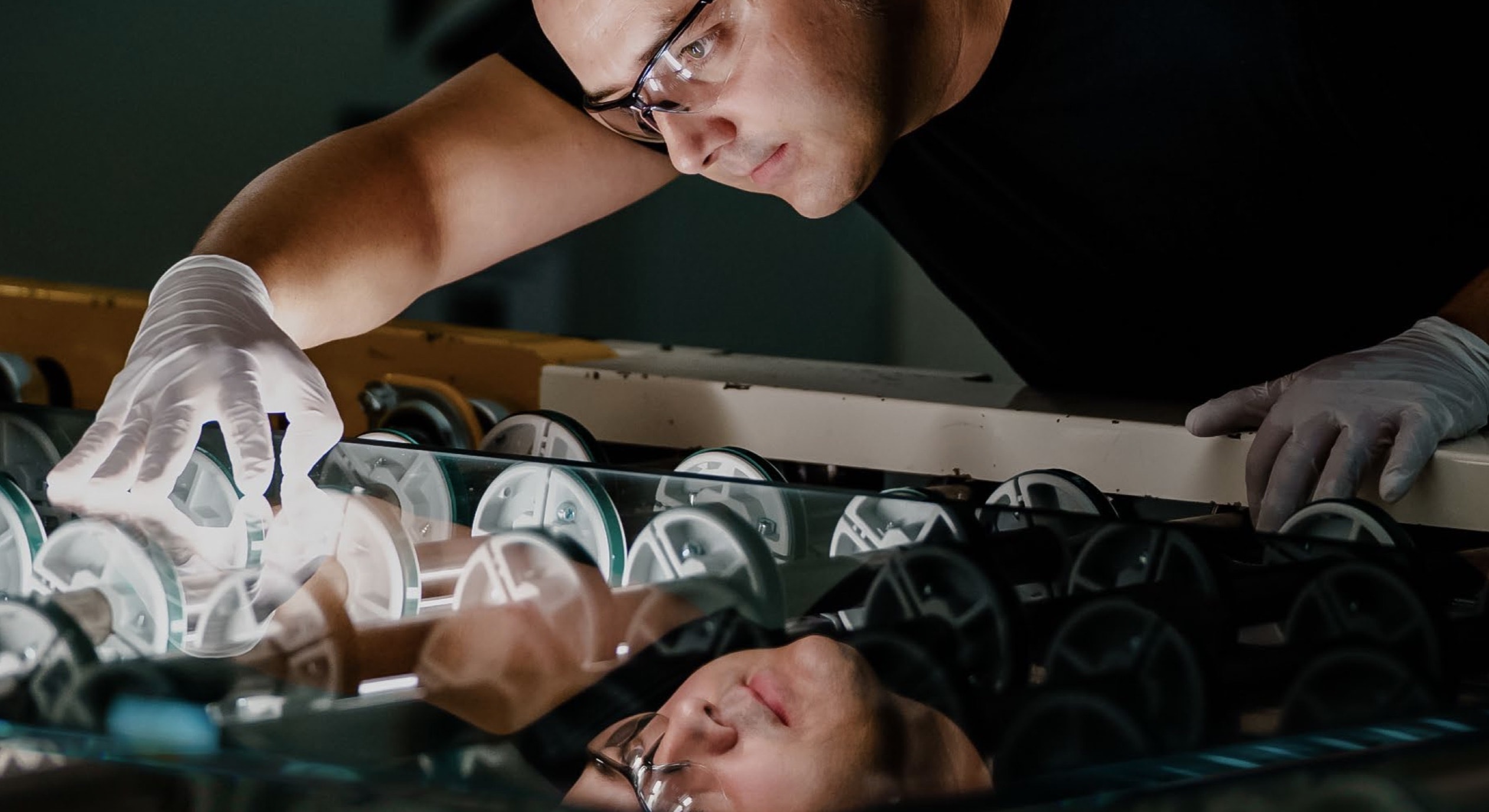 Apple supply chain worker inspecting glass