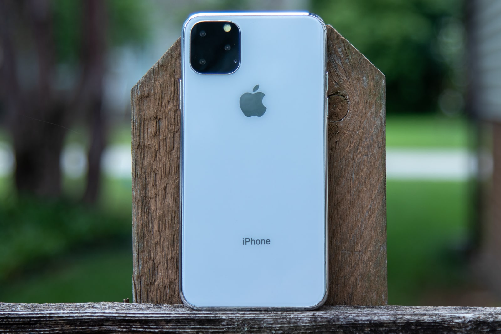 iPhone 11 Max leaning on fence post