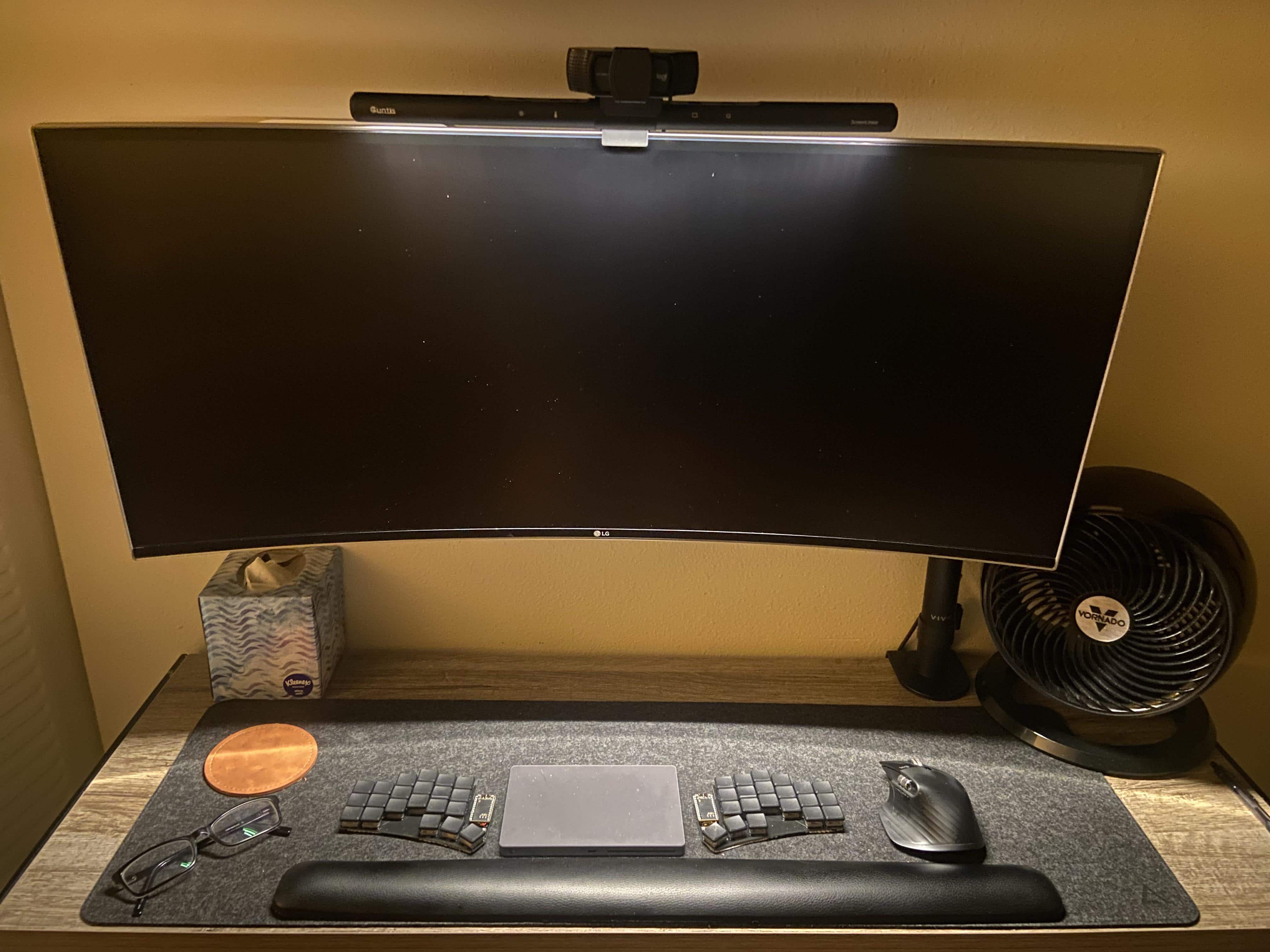 The Mac mini is mounted behind the monitor. And, yeah, the Magic Trackpad in the middle of the split keyboard is backwards on purpose.