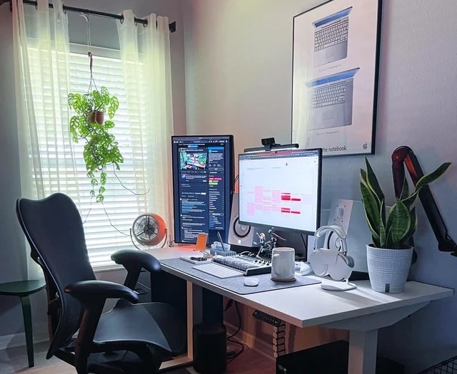 Adding a second 27-inch monitor in portrait mode enhanced the setup. And look at that classic PowerBook G4 poster!