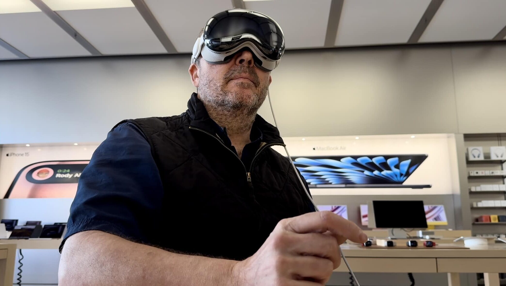 A fat old guy getting a demo of Apple Vision Pro at an Apple retail store.
