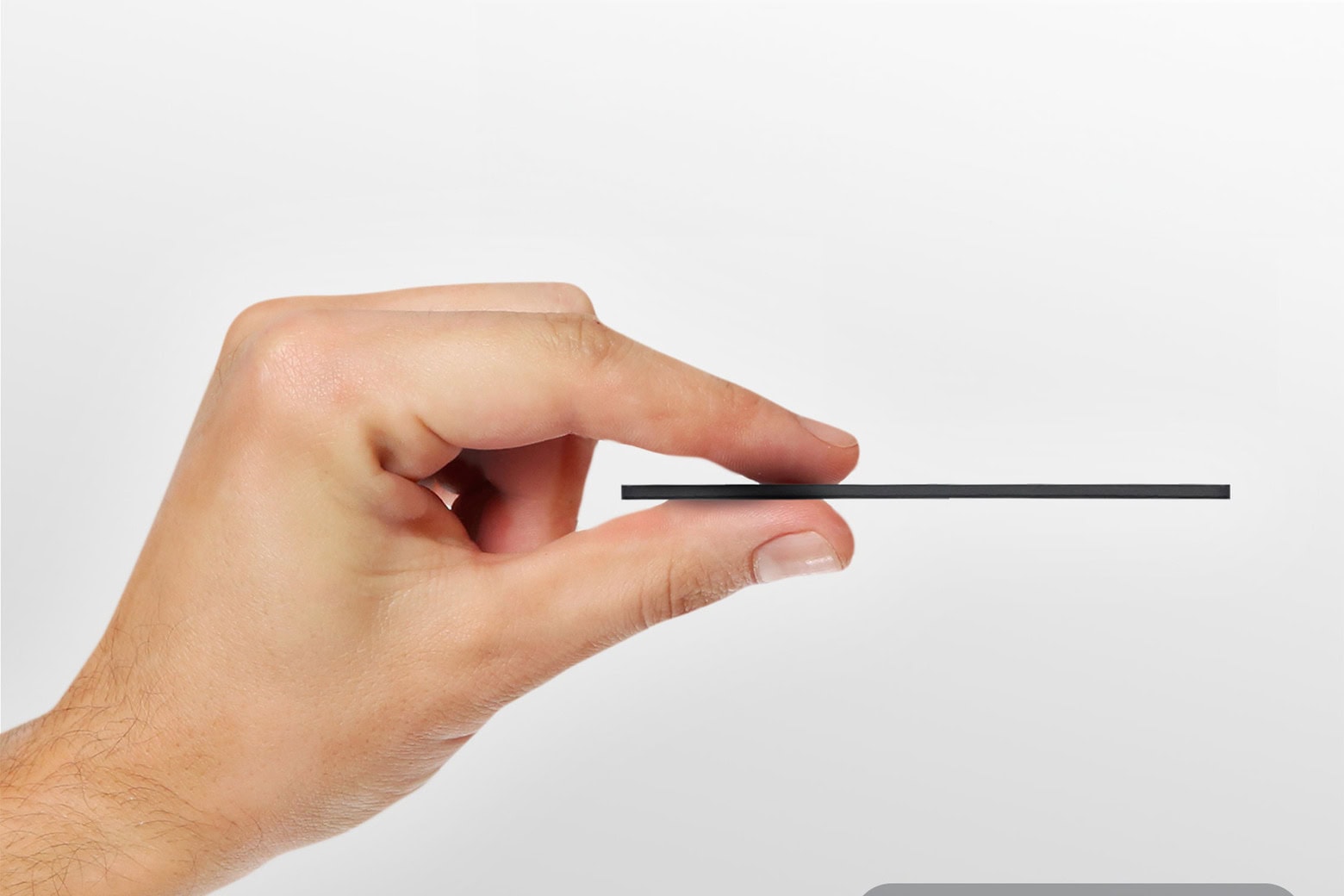 Side photo shows slim KeySmart SmartCard wallet tracker held between two fingers.