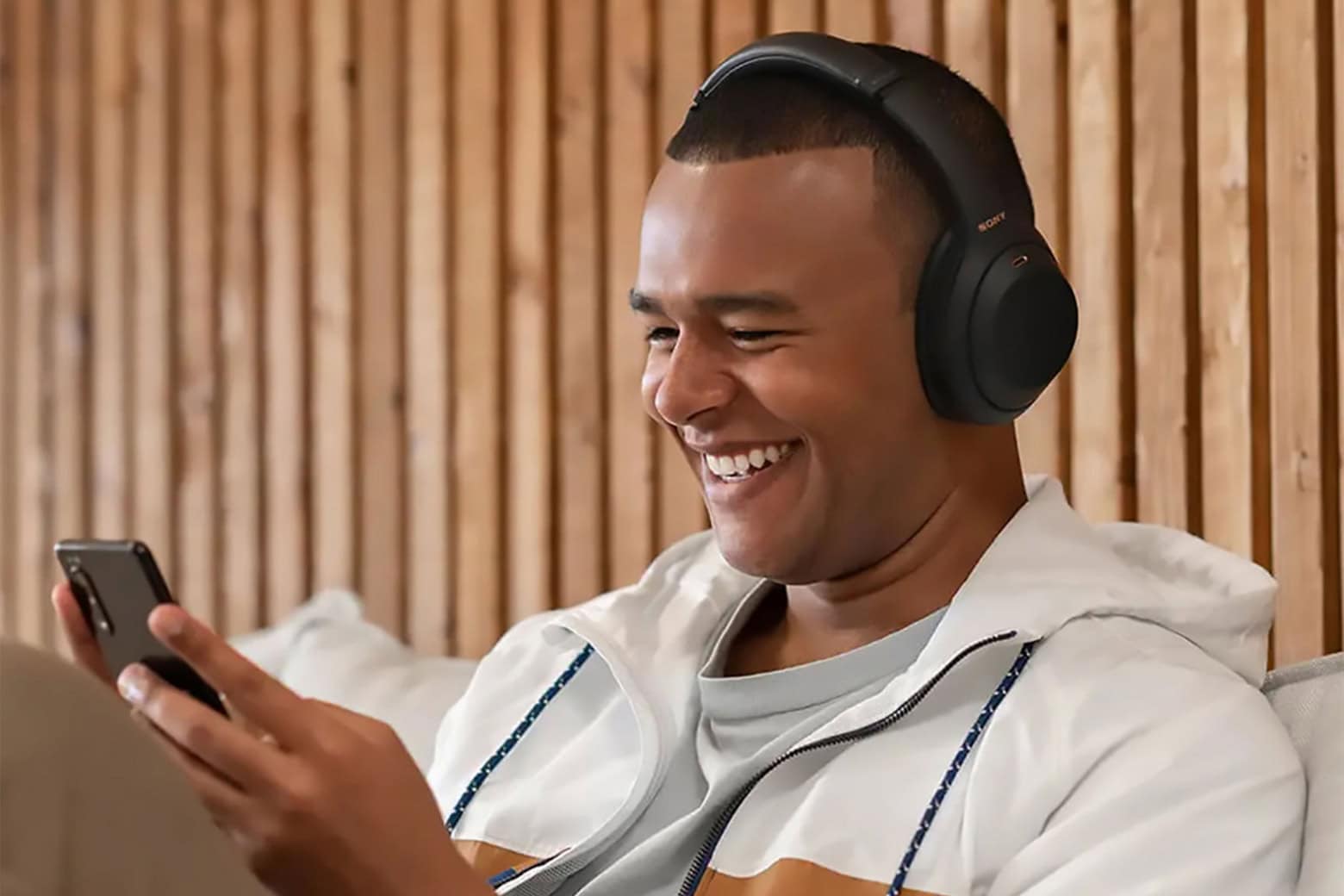 Man wearing the Sony WH-1000XM4 headphones, now available at a great sale price.