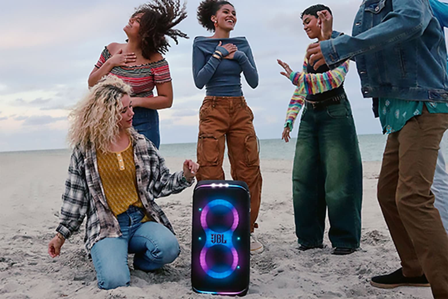 Partying with friends by the seaside with the JBL PartyBox Club 120 portable wireless party speaker.