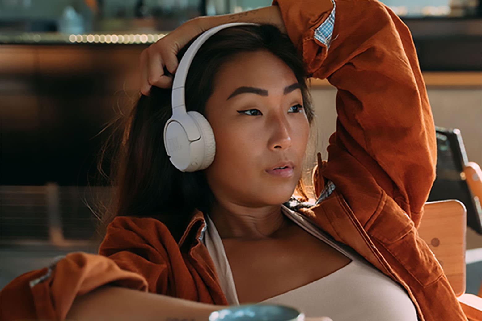 Woman wearing the JBL Tune 520BT On-Ear Wireless Headphones.