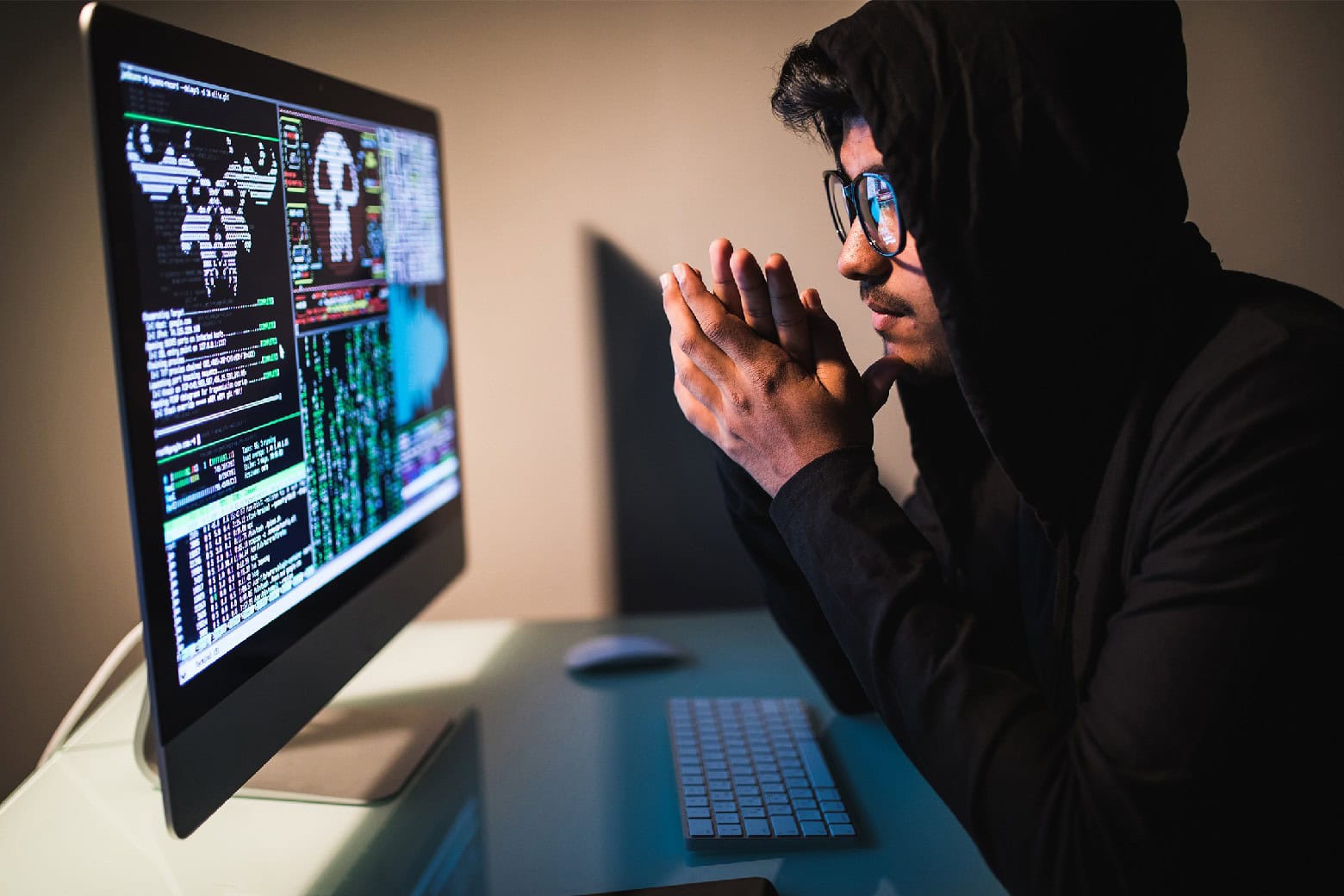 A man looks at a computer, used to illustrate a post on The 2024 All-in-One Ethical Hacking Course Bundle, which lets you learn hacking.