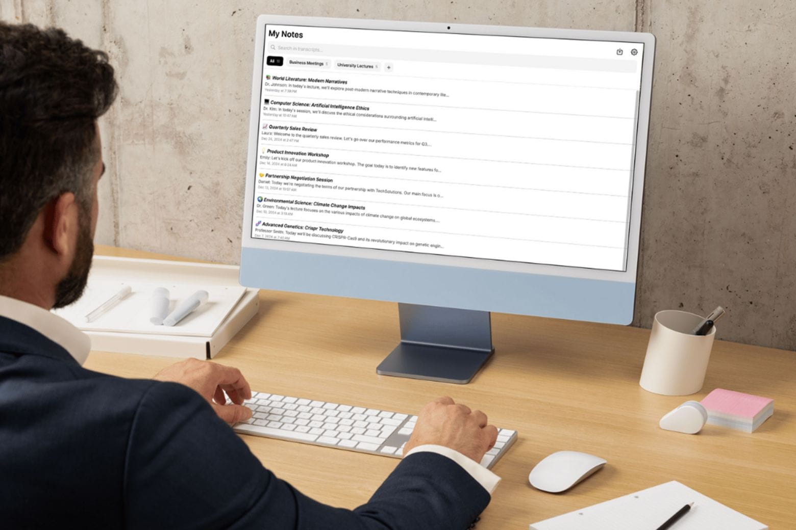 Man working in front of a computer using AI note taker app My Noes AI