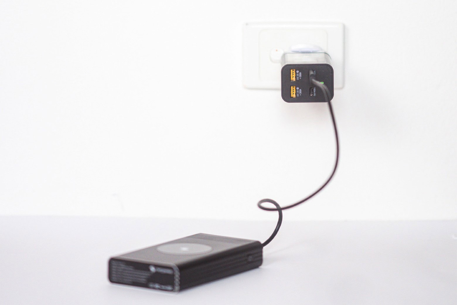 Plugged charger charging a device.