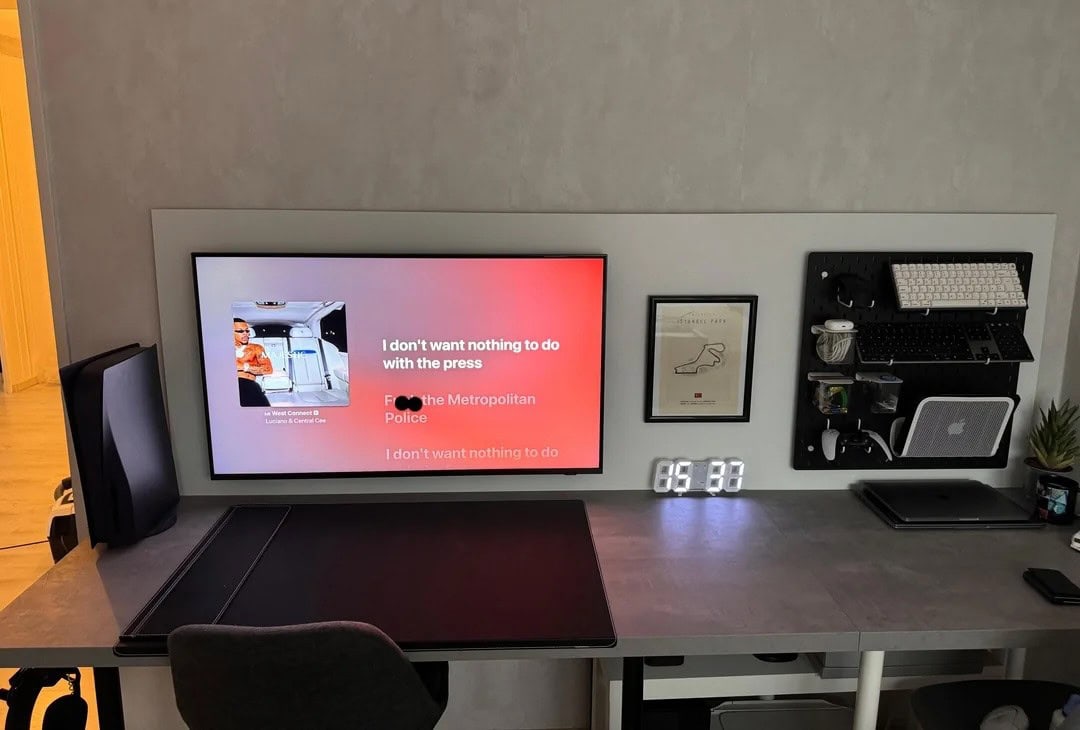 MacBook setup with wall-mounted display