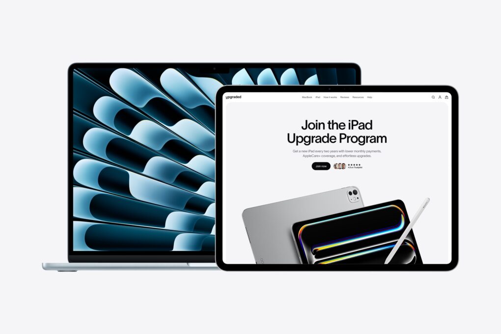 Photo of a MacBook and iPad with the Upgraded MacBook monthly payments plan, with an image on-screen that says 