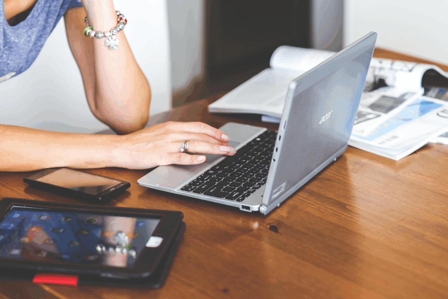 Lady working with her laptop on a desk.